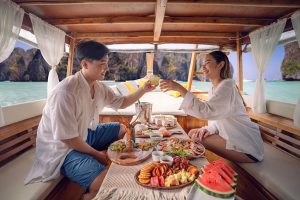Asian-couple-on-boat-dining-at-Koh-phi-phi-island-640
